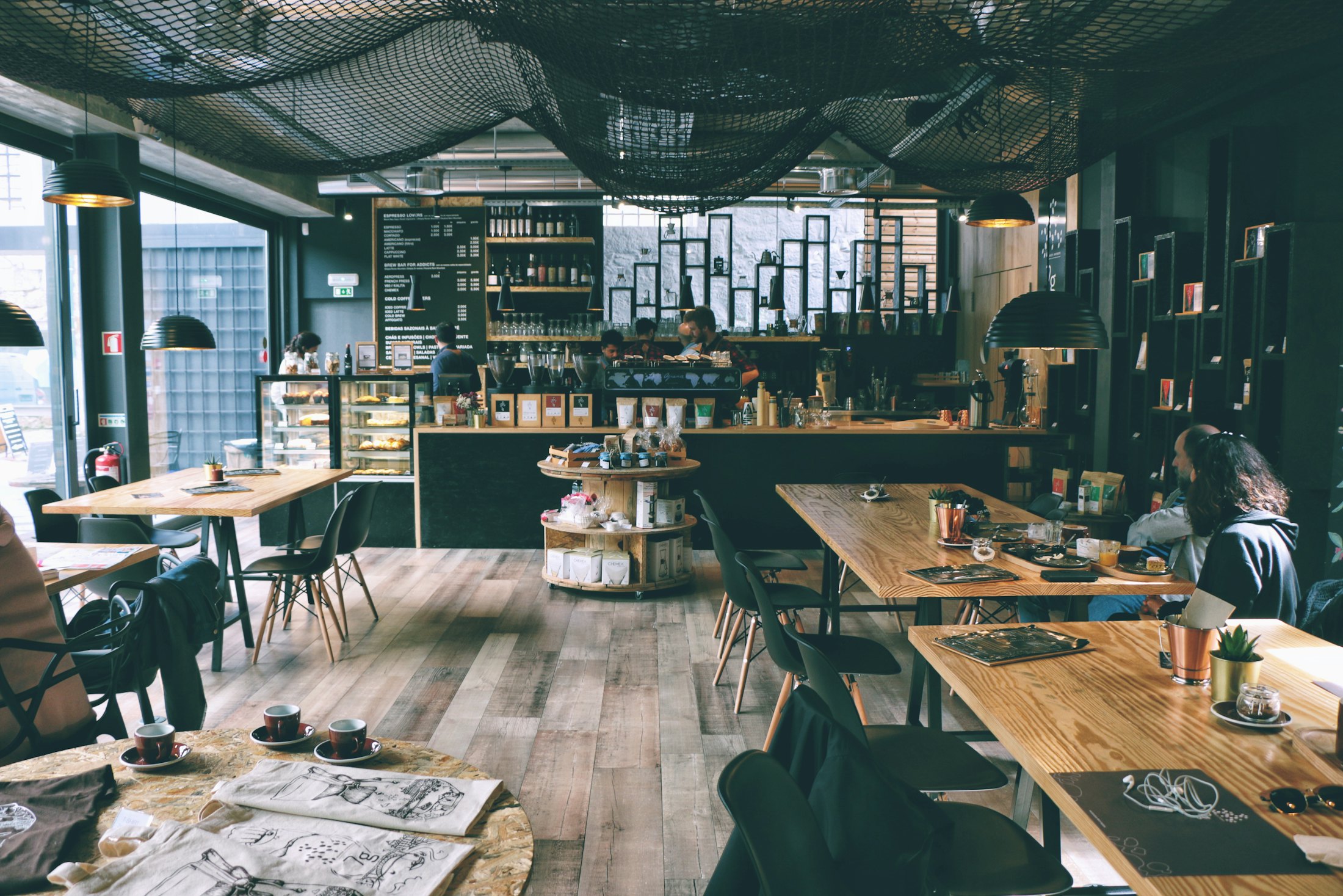 Inside the Household Coffee shop, timber tables and a lit counter