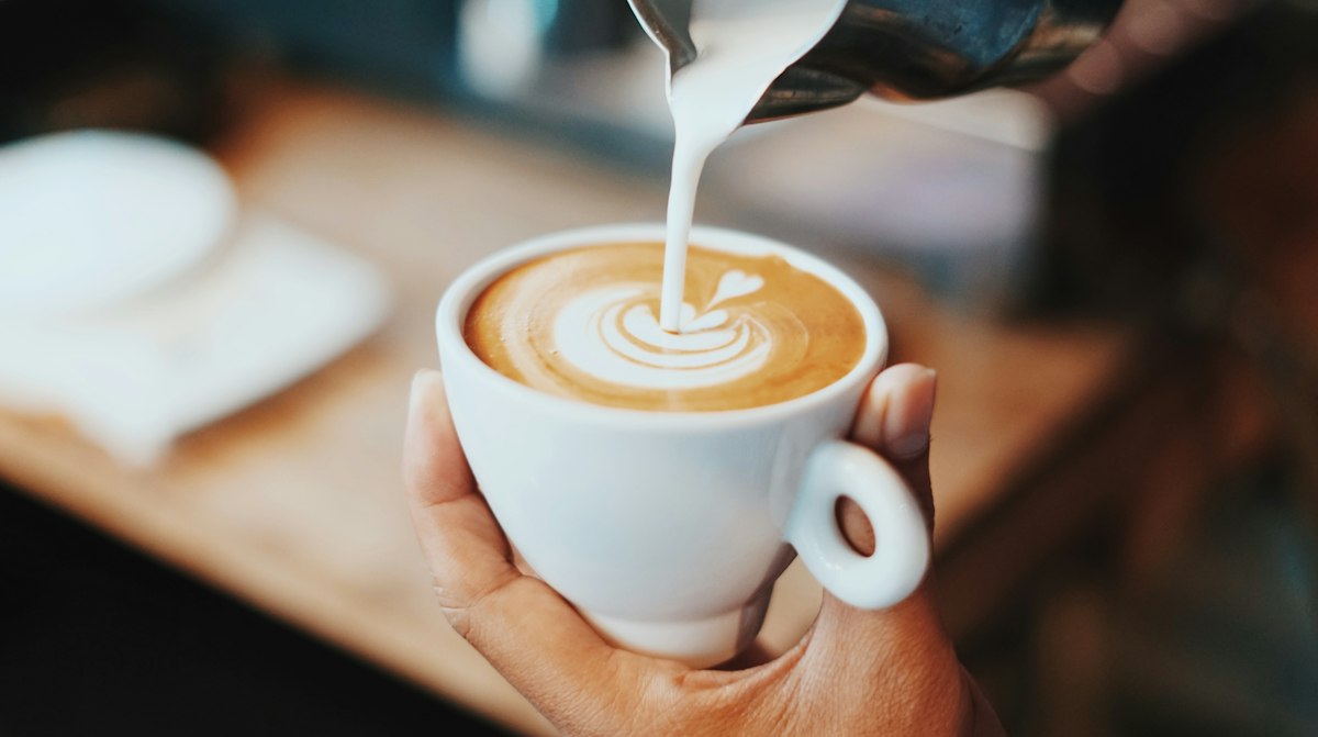 Milk being poured into a flat white at the Household Coffee bar